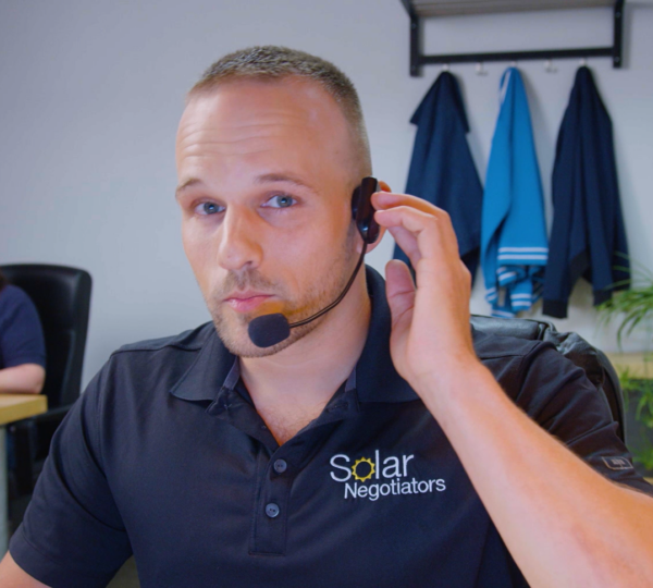 image of Solar Negotiators employee wearing a headset talking to a client