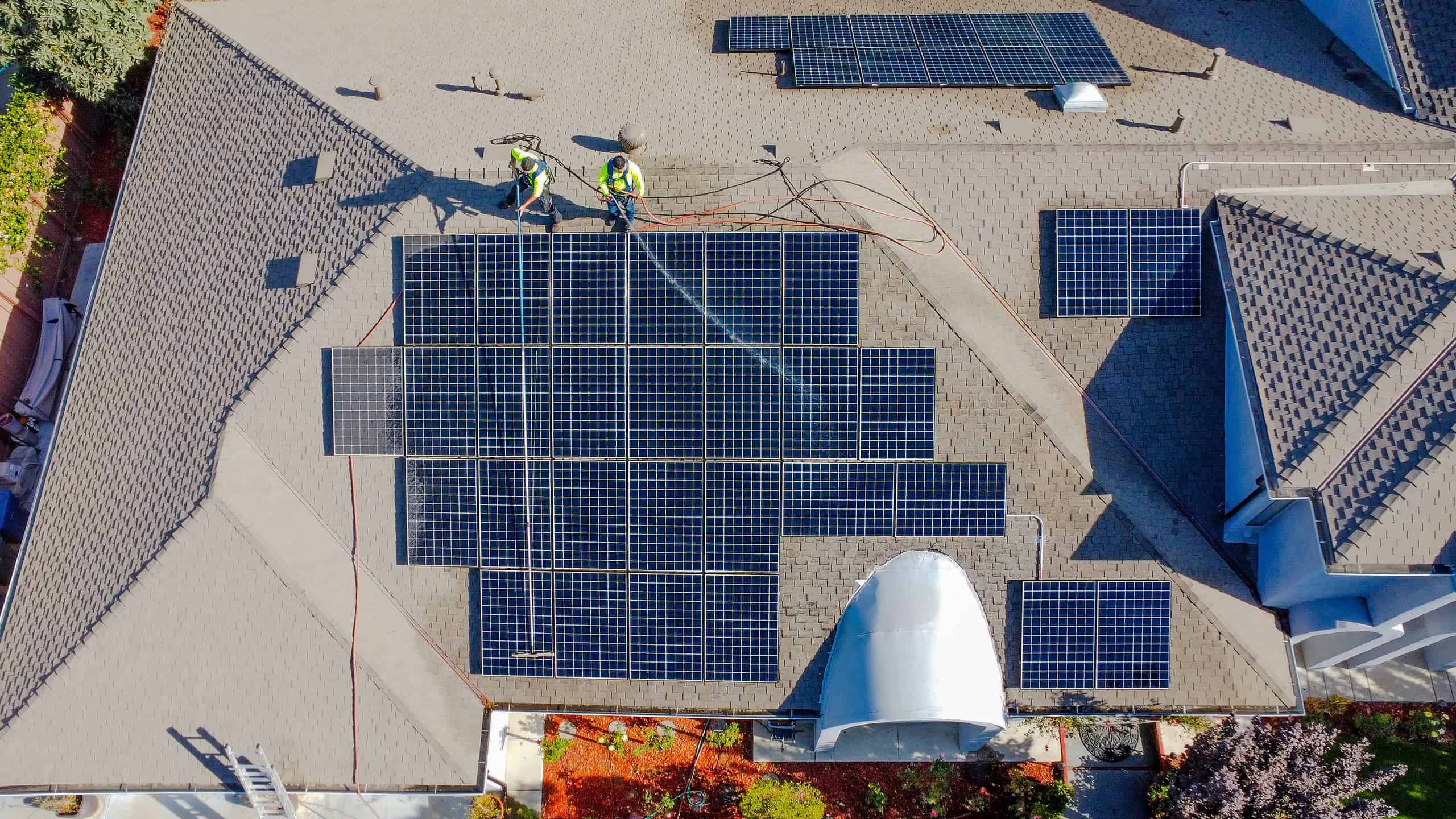 bird eye view of solar panel cleaners on the job