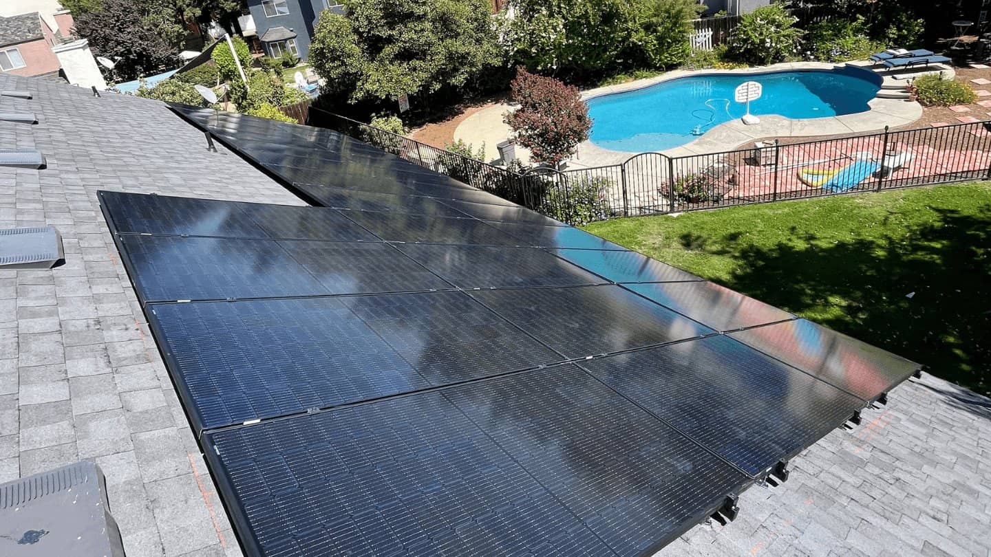 solar panels on a roof of a house overlooking the swimming pool