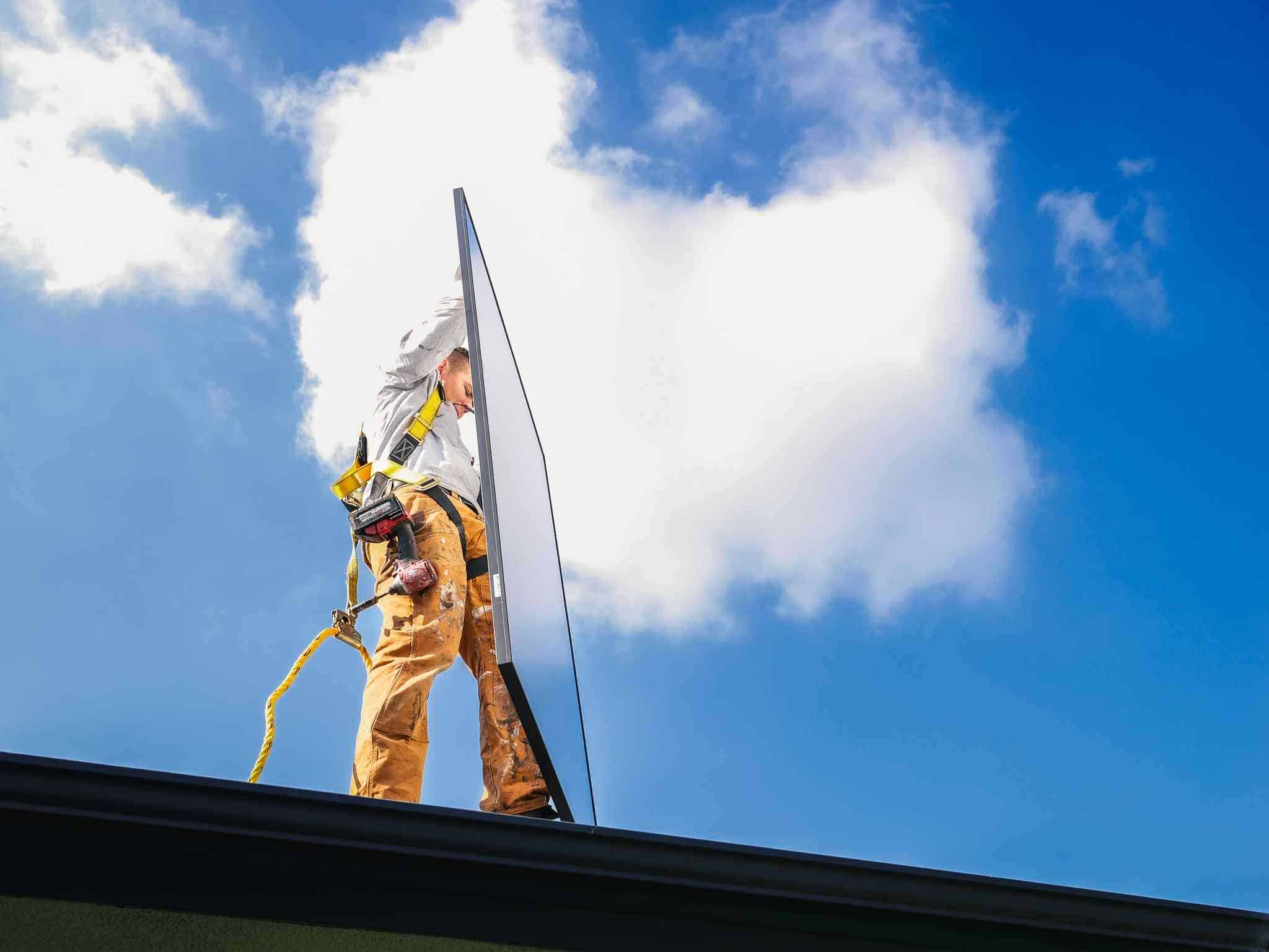 solar maintenance crew holding panel