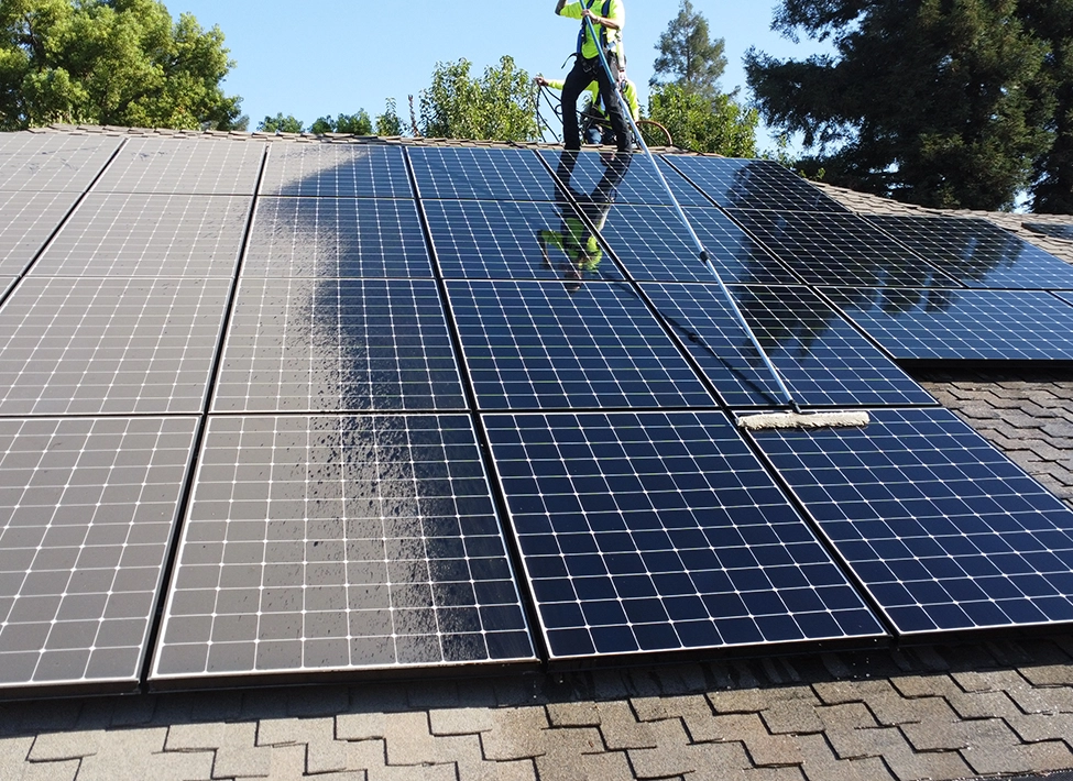 solar technician performing panel cleaning